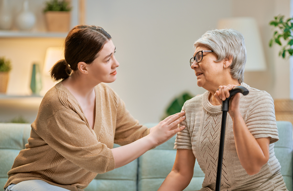 Woman comforting an older woman.