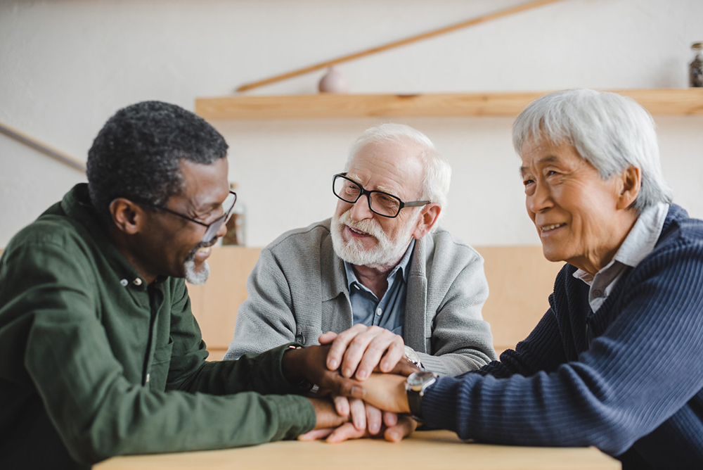 Three men conversing together.