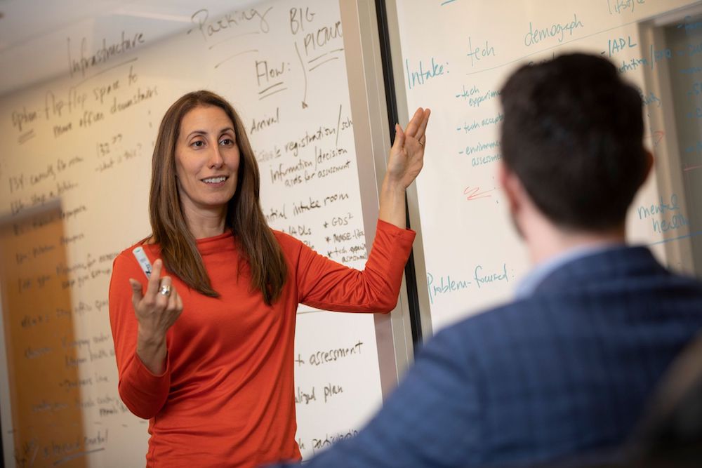 A woman teaching a man.