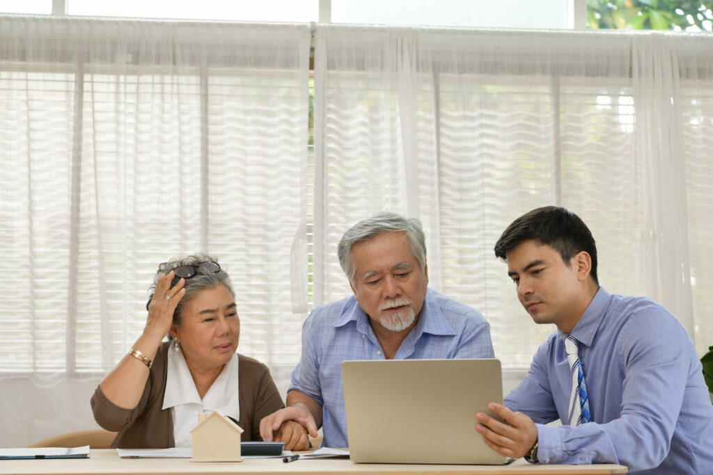 Senior couple discussing financial plans with financial advisor.